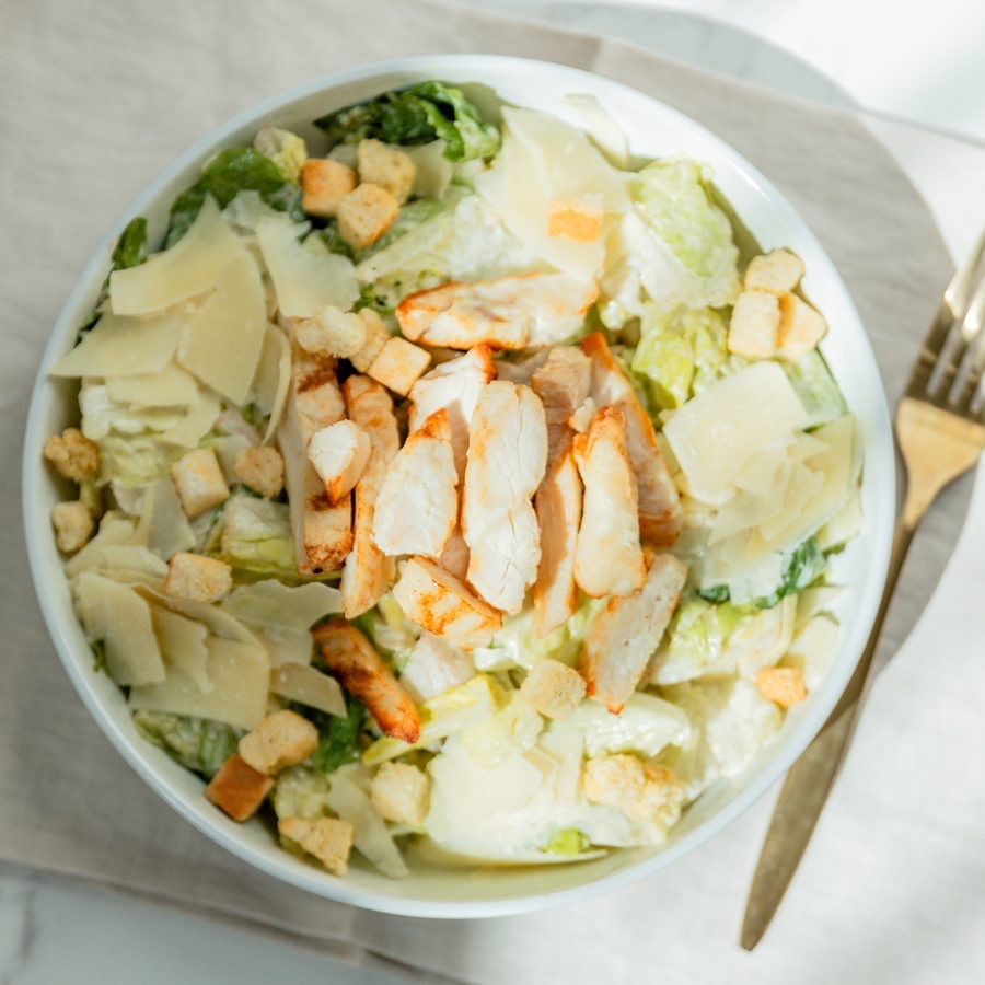 Chicken Caesar Salad — chopped romaine with grilled chicken, croutons, shaved parmesan and Caesar dressing