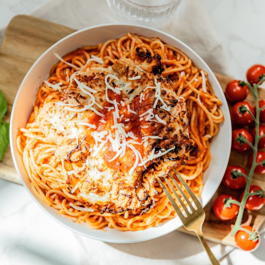 Spaghetti Chicken Parmesan — spaghetti in rose red sauce with breaded chicken and parmesan