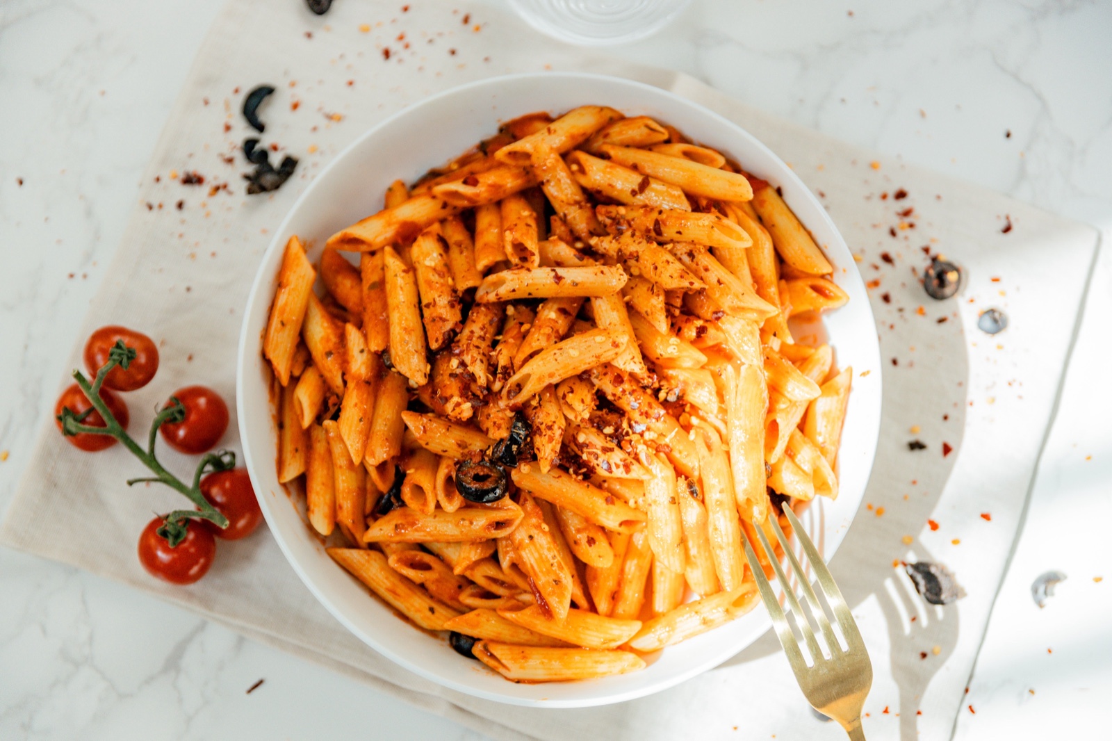 Penne in red sauce overhead with cherry tomatoes — Pastaphony Glendora