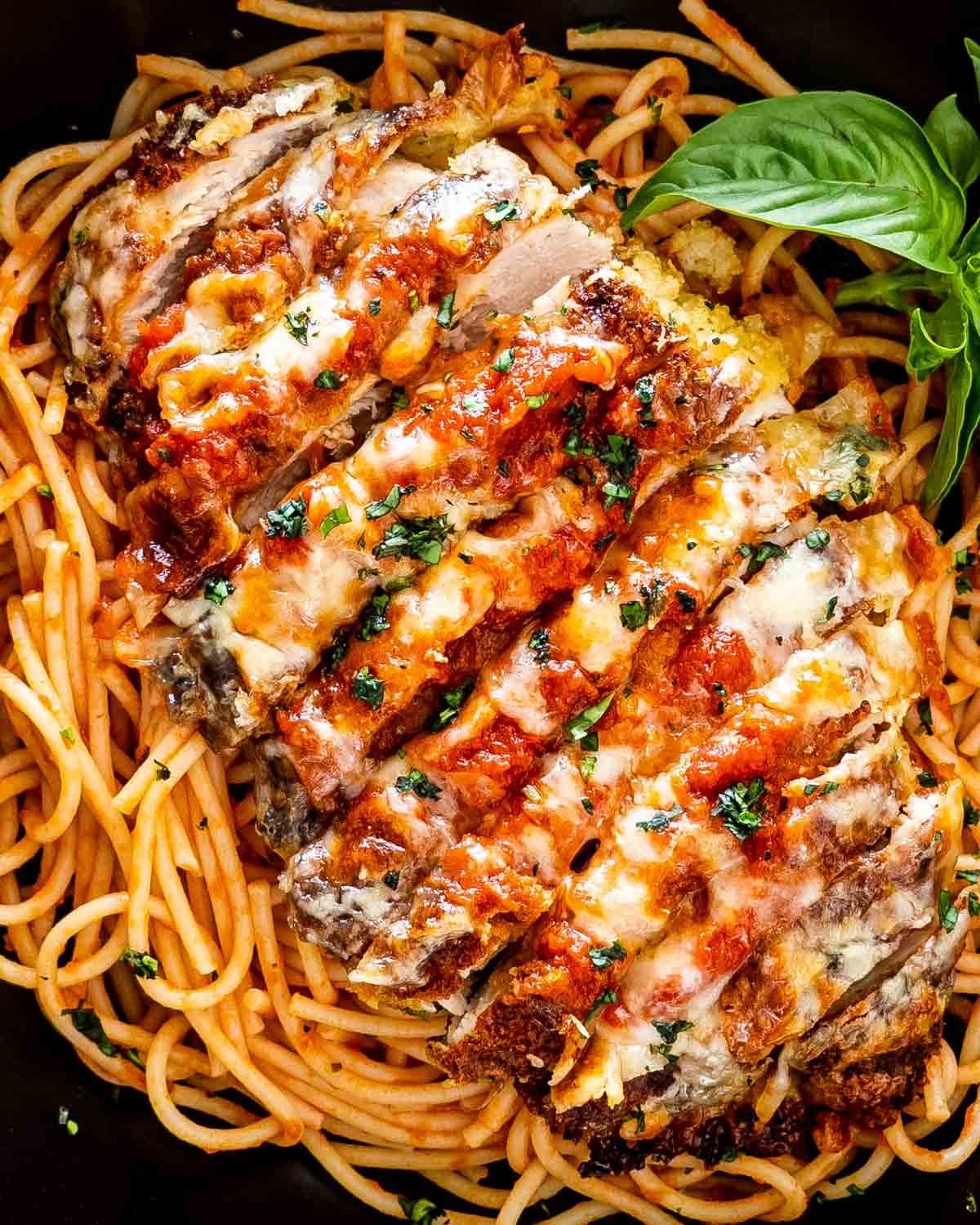 Spaghetti Chicken Parmesan with melted cheese and basil at Pastaphony Fullerton